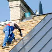 Man on roof doing maintenance after a building inspection